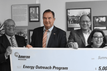 Mike Kehoe holding an Ameren check